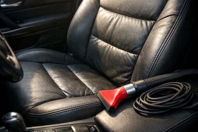 Vehicle interior being vacuumed during an express detailing appointment in Fort Worth