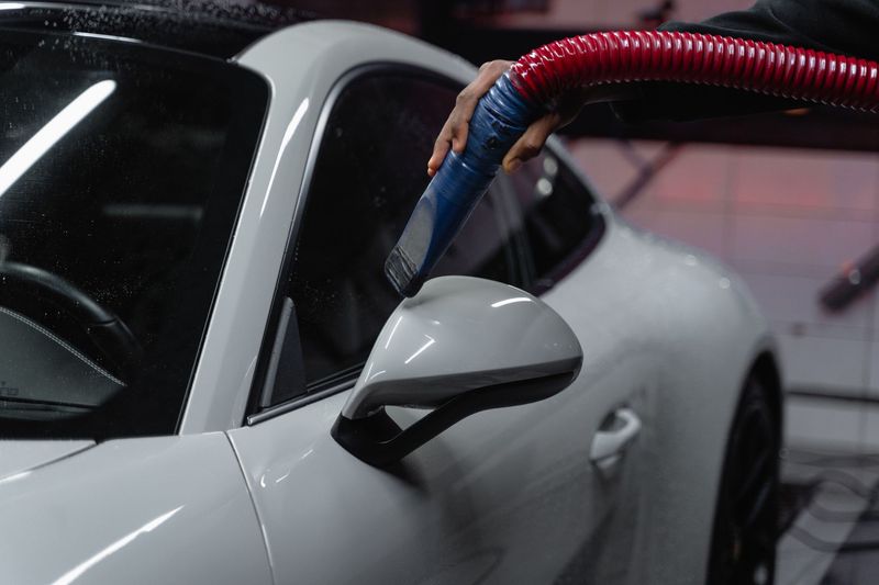 Automotive detailer carefully washing a vehicle during a mobile service in Fort Worth, Texas